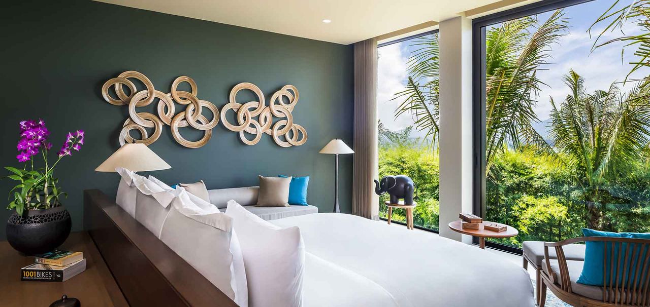 Villa bedroom with a green accent wall